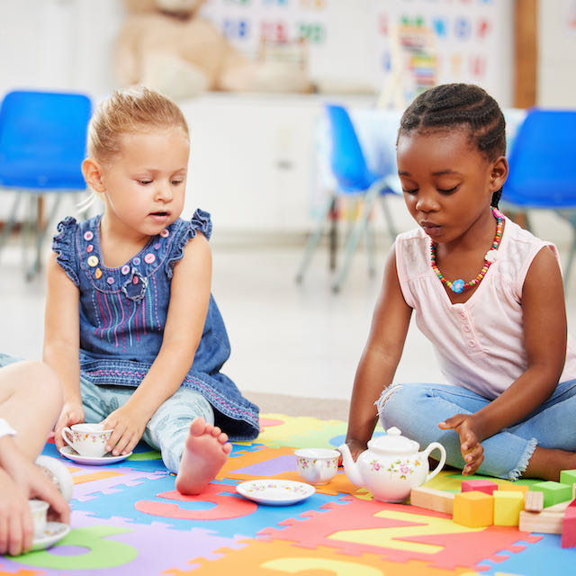 Young girls enjoying a tea party, engaging in imaginative play at Learning Ladder Christian Preschool